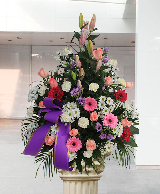Envío de flores funerarias en tonos rosas